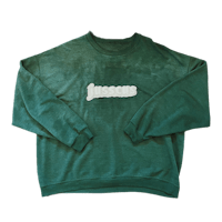 a green sweatshirt with a white logo on it